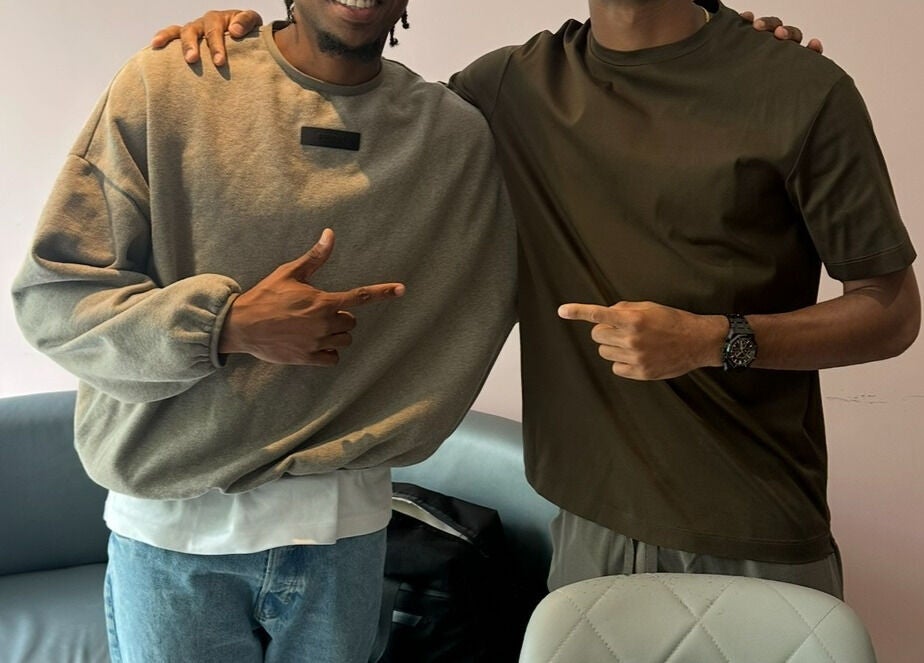 Two people smiling and pointing at each other inside Jefe Barbers - Stockport, Stockport, England, GB.