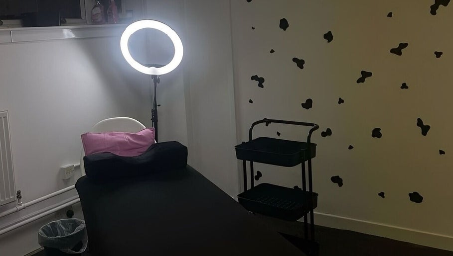 Relaxing treatment room at Beauty By Amc, Glasgow, Scotland, GB, featuring a cozy bed and bright ring light.