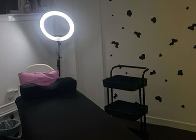 Relaxing treatment room at Beauty By Amc, Glasgow, Scotland, GB, featuring a cozy bed and bright ring light.