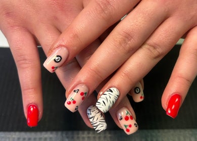 Vibrant nail art at Beauty By Amc in Glasgow, Scotland, GB showcasing red, cherry, and zebra designs.