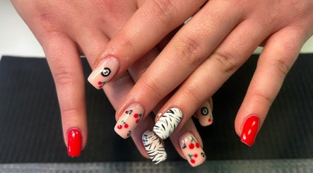 Vibrant nail art at Beauty By Amc in Glasgow, Scotland, GB showcasing red, cherry, and zebra designs.