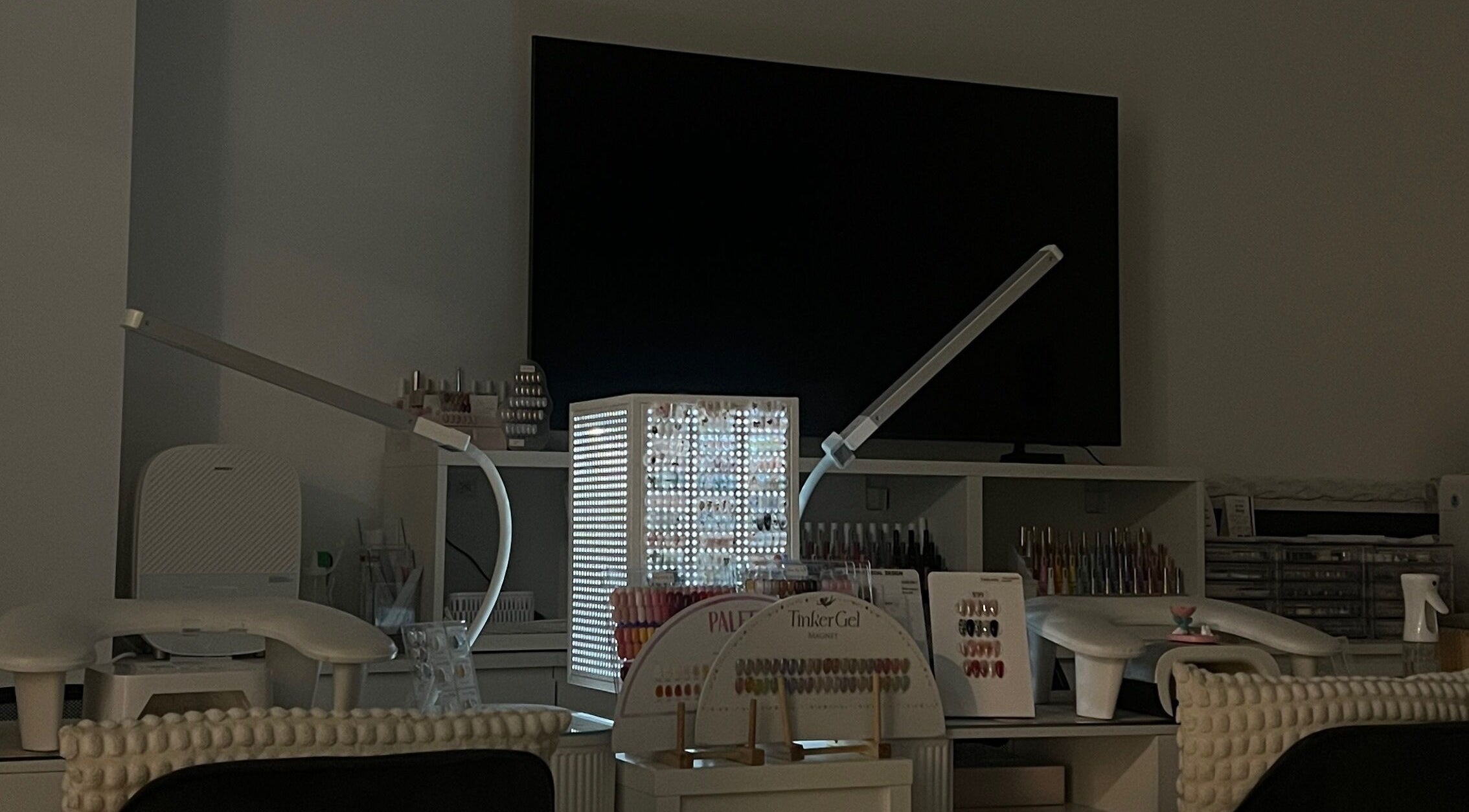 Bloom Nail Beauty workspace in Burwood, New South Wales, AU featuring nail polish display and modern lighting.