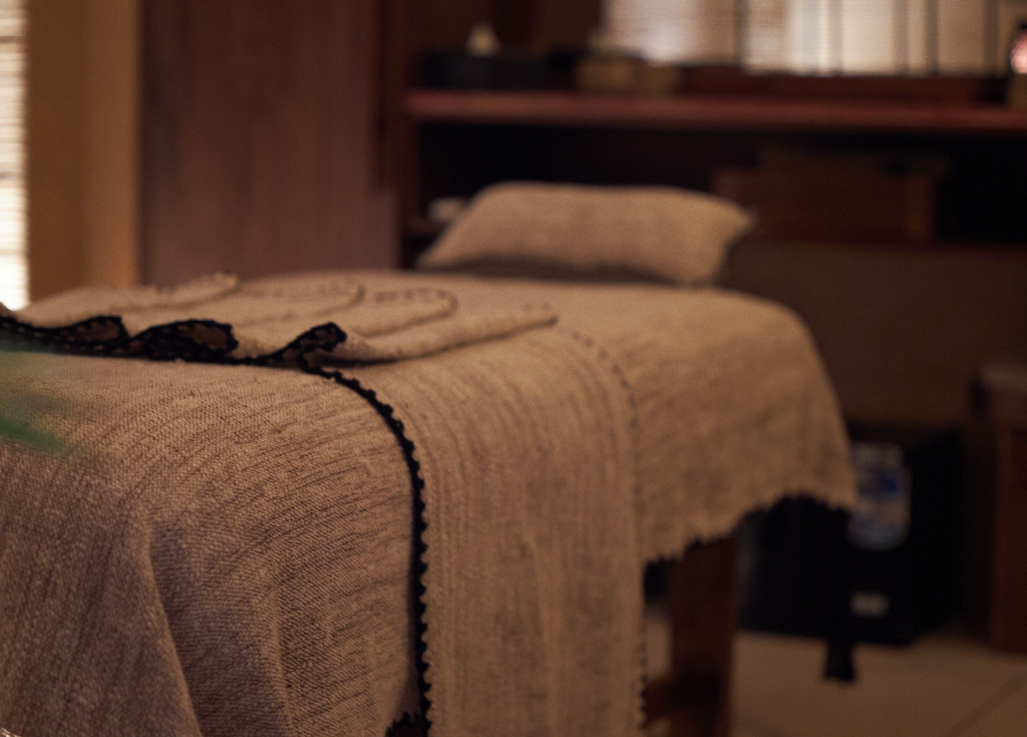 Cozy massage room at ATMOS BodyLab, Bali, Bali, ID with a neatly draped treatment bed for ultimate relaxation.