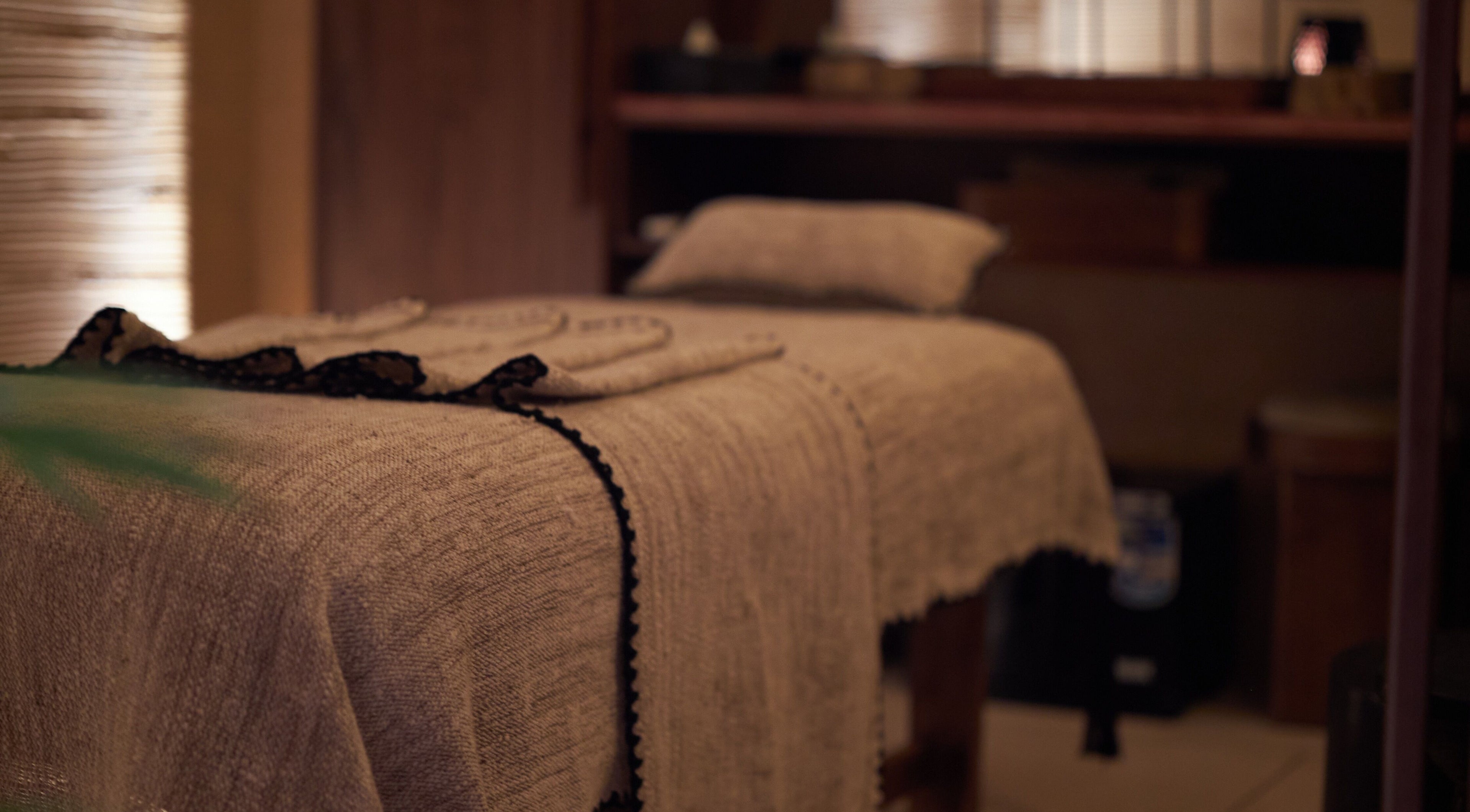 Cozy massage room at ATMOS BodyLab, Bali, Bali, ID with a neatly draped treatment bed for ultimate relaxation.