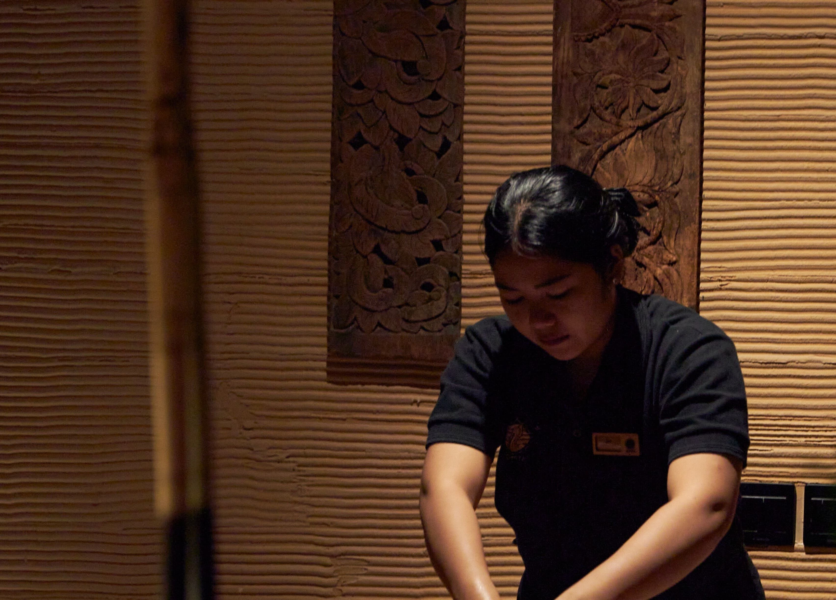 Therapist at ATMOS BodyLab in Bali, Bali, ID providing a calming massage service.