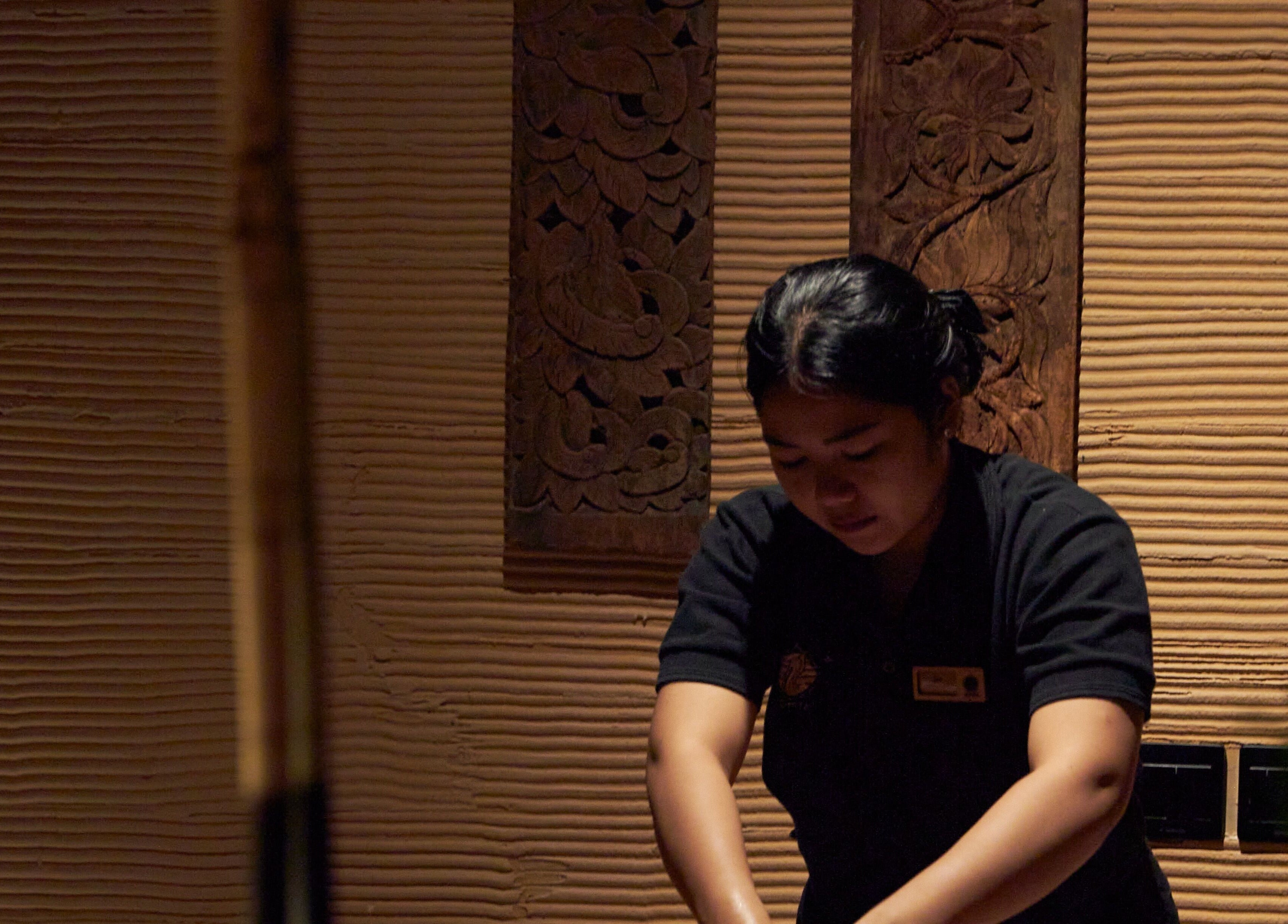 Therapist at ATMOS BodyLab in Bali, Bali, ID providing a calming massage service.