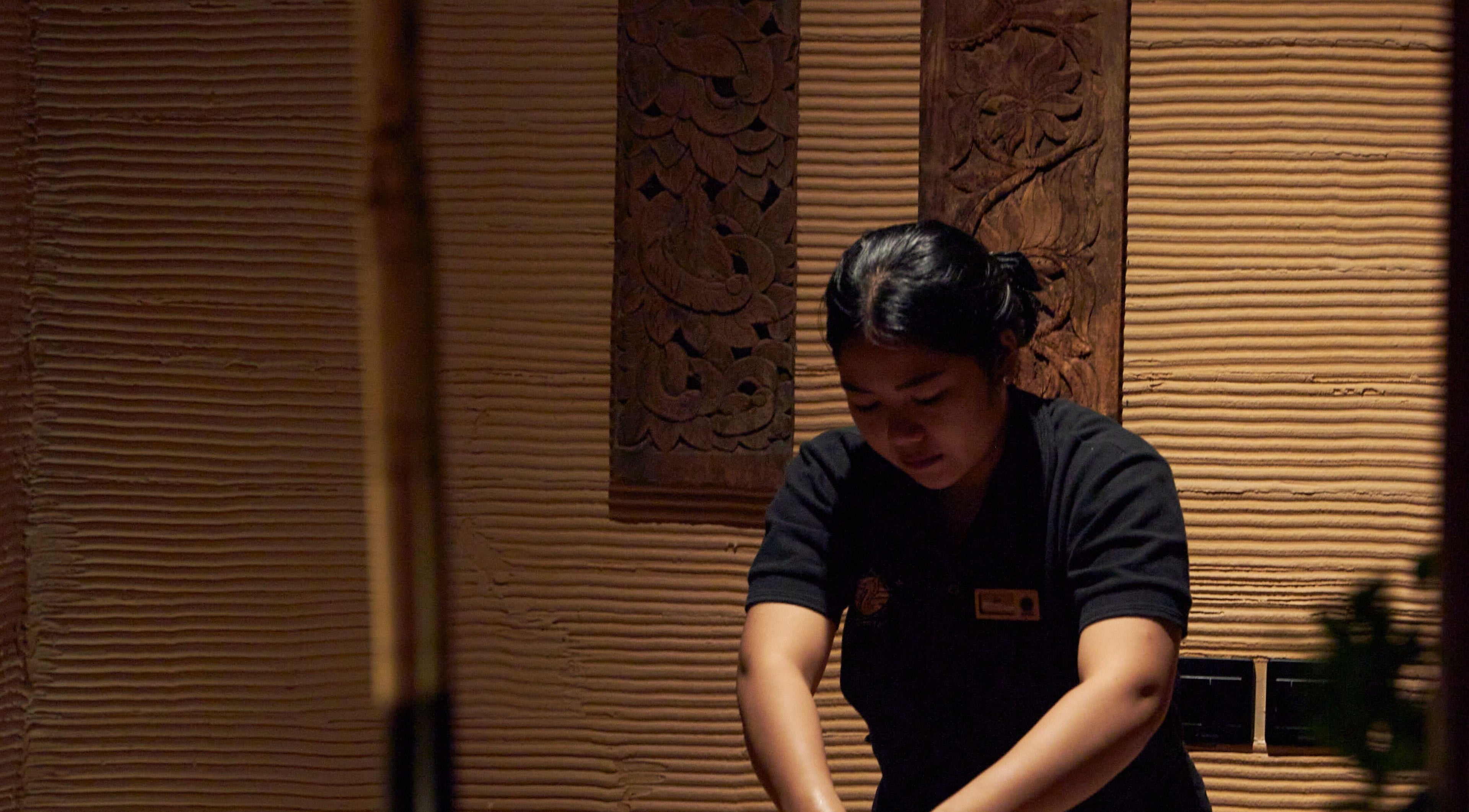 Therapist at ATMOS BodyLab in Bali, Bali, ID providing a calming massage service.