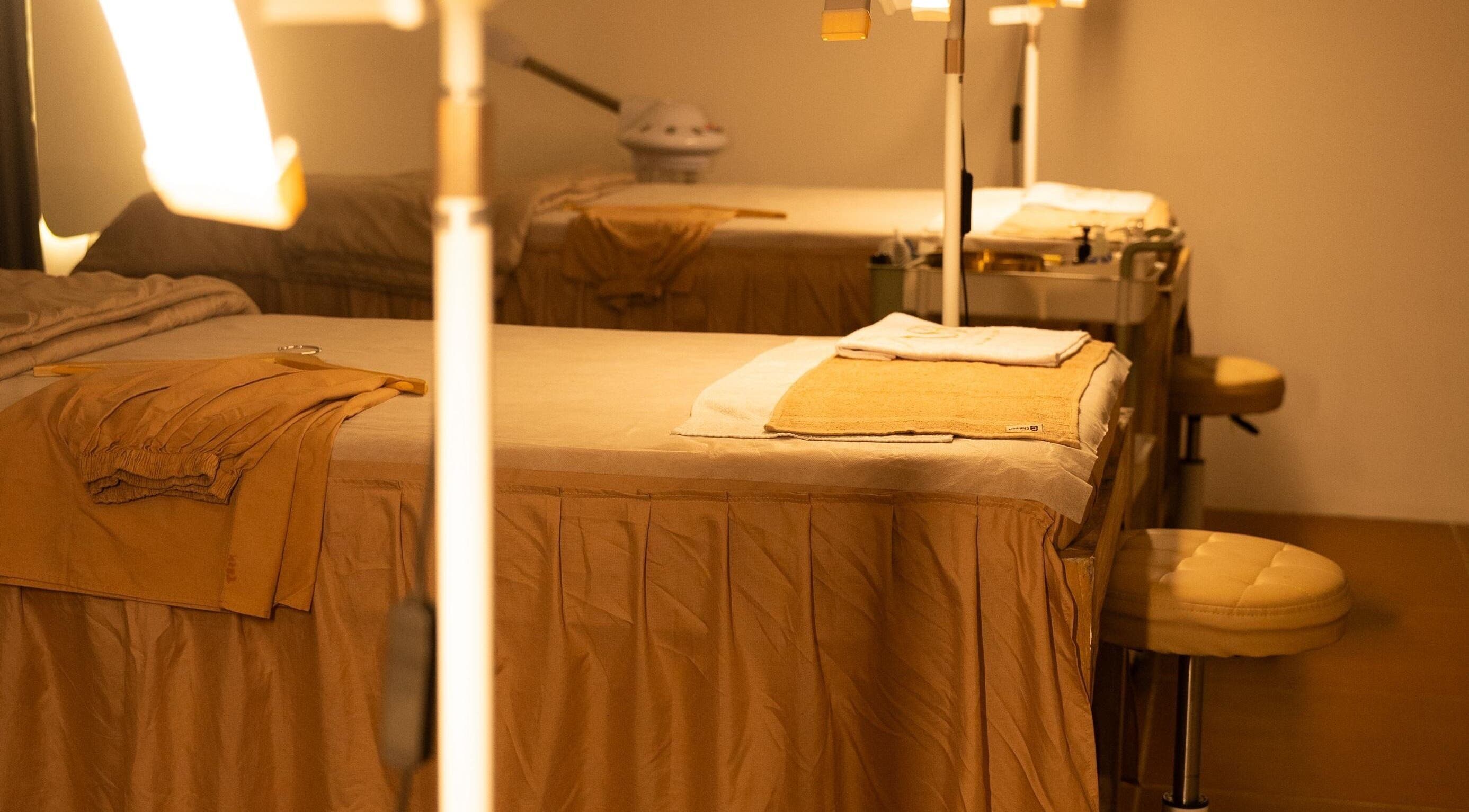 Tranquil treatment room at NSB Beauty Studio Bukit Jimbaran, Bali, Bali, ID, featuring warm lighting and comfortable beds.