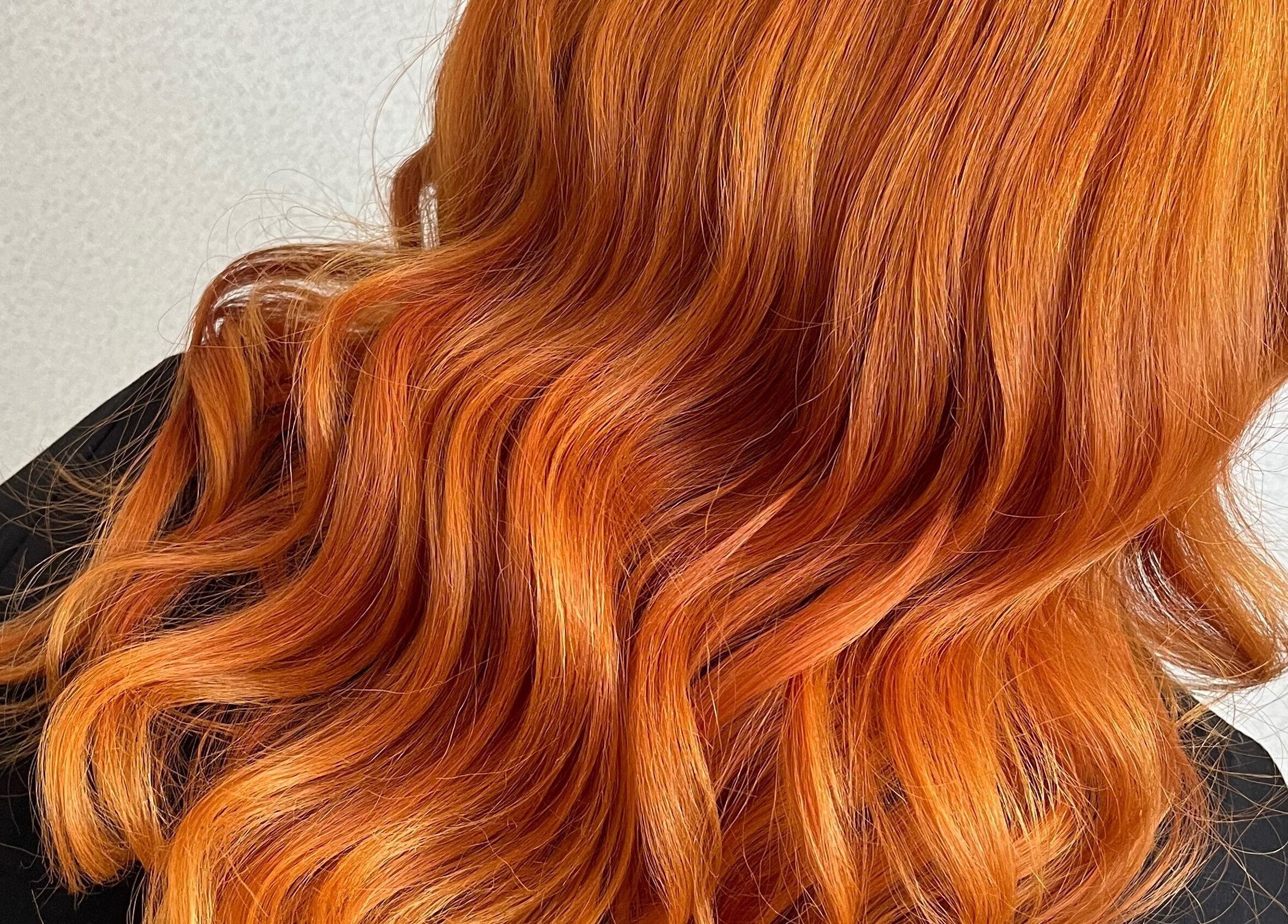 Vibrant orange hair styled in soft waves at Lana Beauty Salon Senawang, Seremban, Negeri Sembilan, MY.