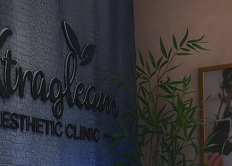 Xtragleam Aesthetic Clinic sign at Monshalasi busstop, Lagos, Lagos, NG, highlighted with plant décor.
