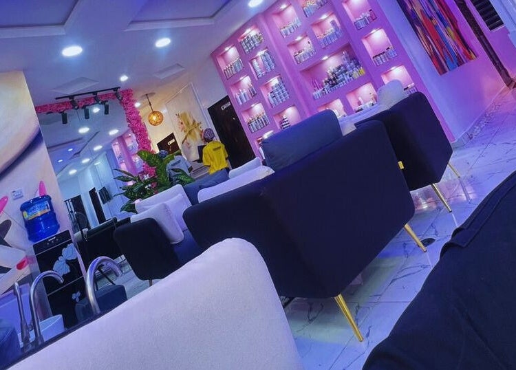 Modern interior of Xtragleam Aesthetic Clinic in Ishara, Ogun State, NG, featuring plush seating and vibrant decor.