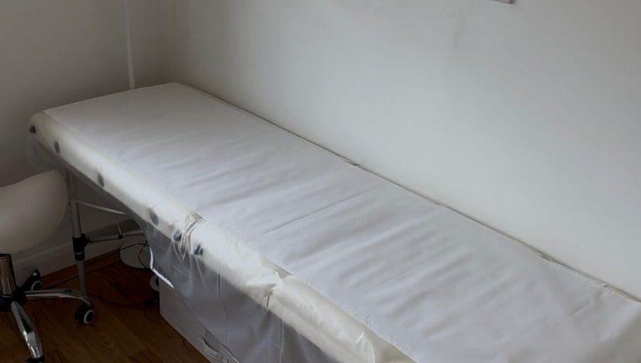 Treatment bed in Allure Cosmetics, Luton, England, GB, offering serene wellness experiences.