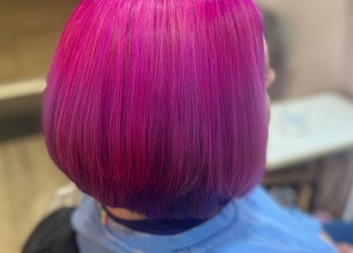 Vibrant pink bob hairstyle at F.P Hairdressing, Warfield, England, GB.