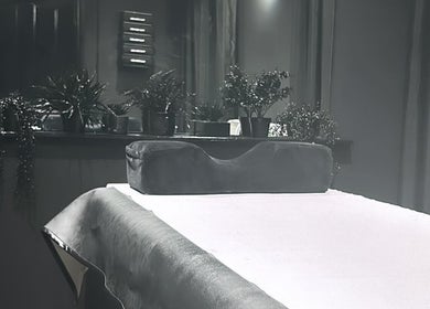 Therapy room at Precision Lifestyle Group in Manchester, England, GB, featuring a massage table with lush greenery.