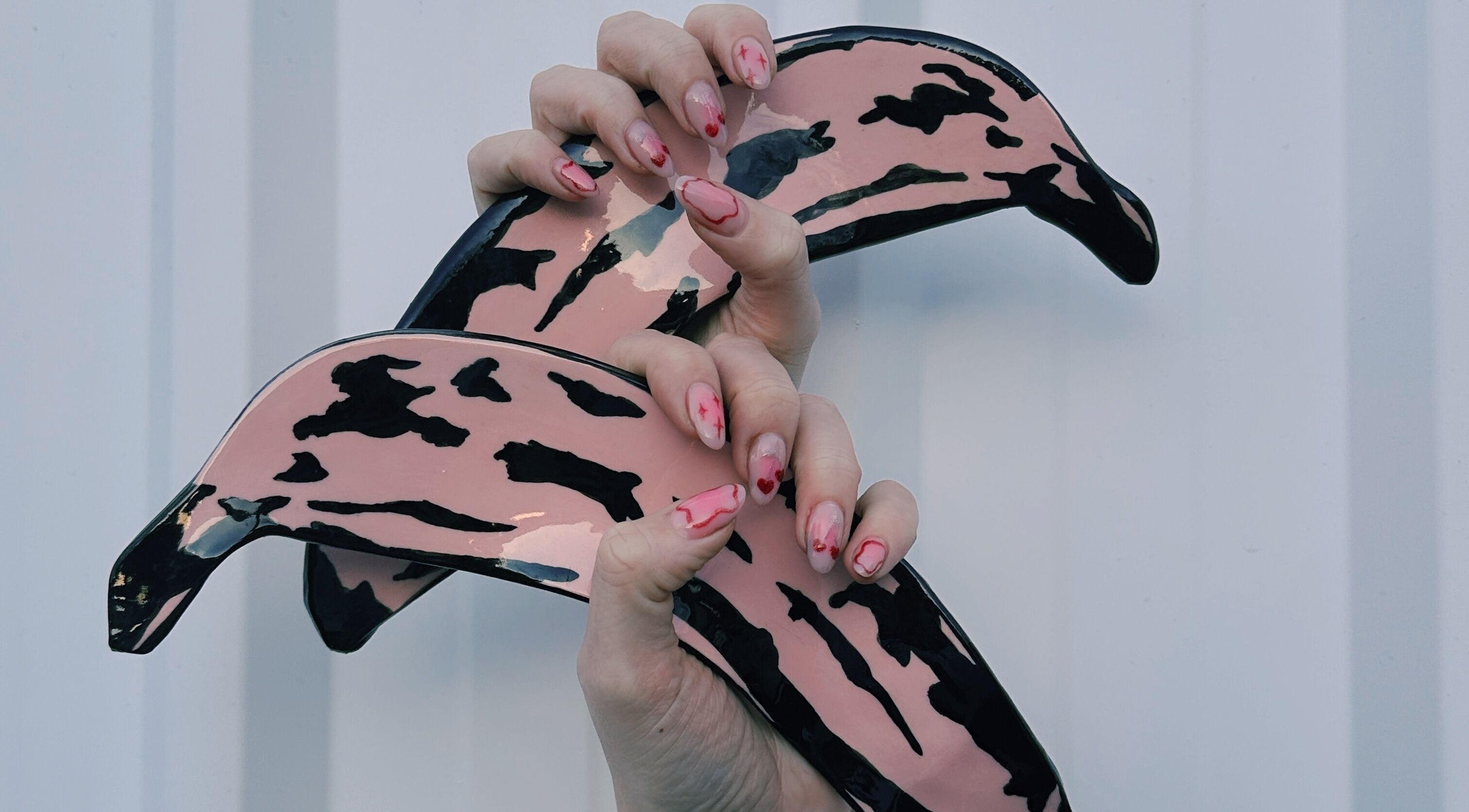 Creative nail art design at Butter Nails, Hamilton, Waikato, NZ, featuring unique pink and black patterns.