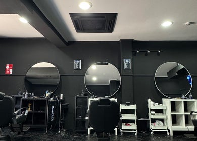 Interior moderno da Brazilian Barber em Amadora, Lisboa, PT com cadeiras e espelhos elegantes.