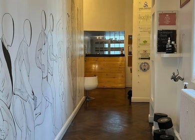 Entrance of Beauty Custom Club Massage Studio in Benton, England, GB, featuring artistic wall design.