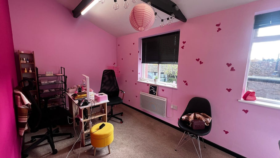 Charming pink interior at Nail-Licious by Emilia in Godmanchester, England, GB featuring heart details and cozy decor.
