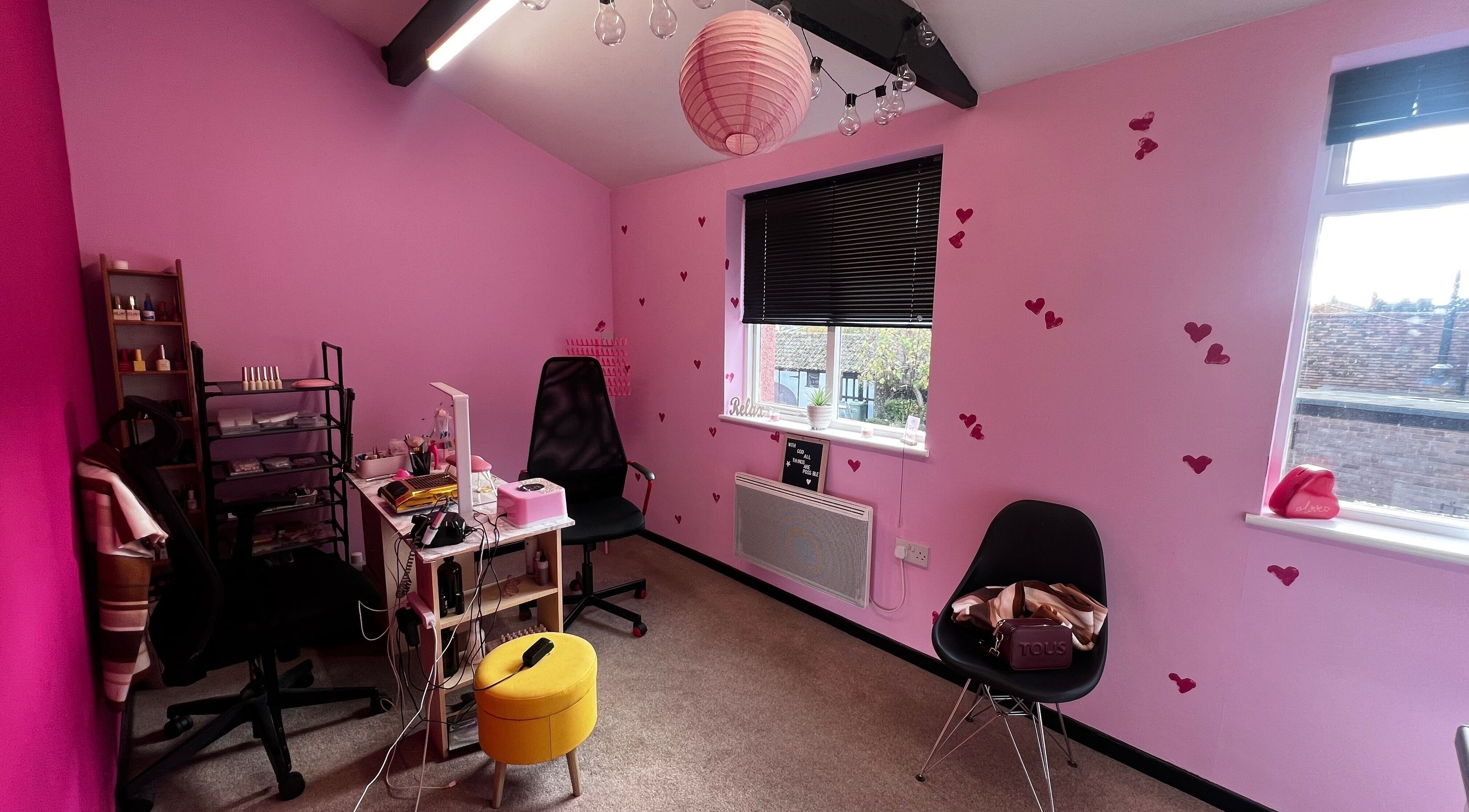 Charming pink interior at Nail-Licious by Emilia in Godmanchester, England, GB featuring heart details and cozy decor.