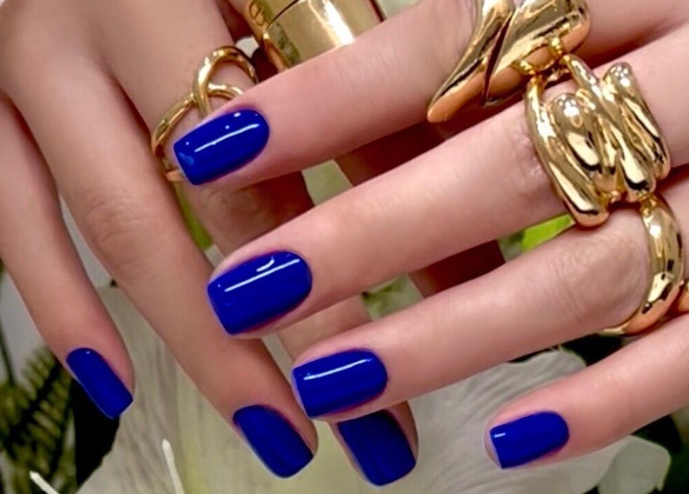 Vibrant royal blue nails with gold rings at Ink & Ivory Nails, Perth, Western Australia, AU.