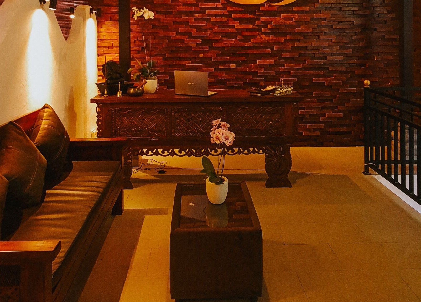 Rustic reception area of Sarira Healing Spa, Bali, Bali, ID, featuring warm lighting and elegant decor.