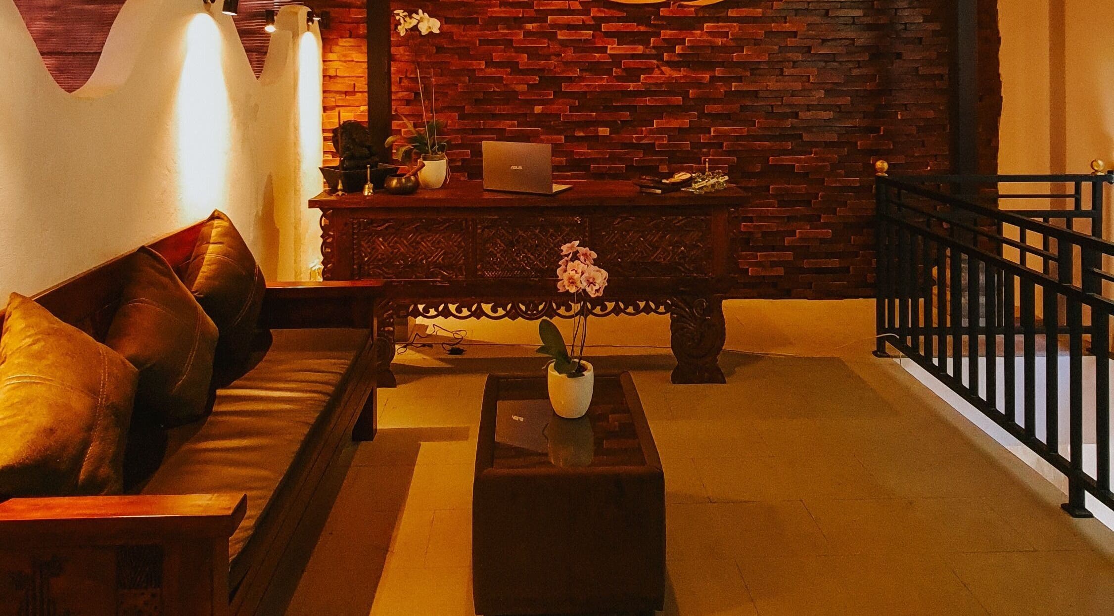 Rustic reception area of Sarira Healing Spa, Bali, Bali, ID, featuring warm lighting and elegant decor.