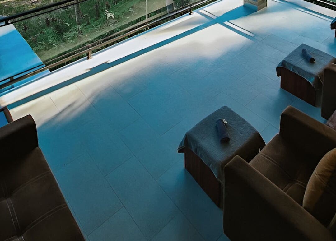 Relaxing open-air lounge at Sarira Healing Spa, Bali. Comfortable seating with serene views. Bali, Bali, ID.