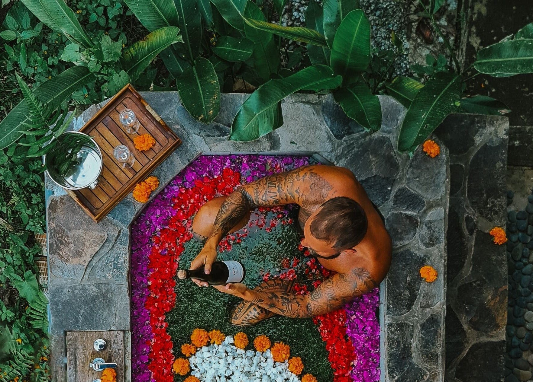 Luxurious flower bath experience at Sarira Healing Spa in Bali, Bali, ID, surrounded by lush greenery.