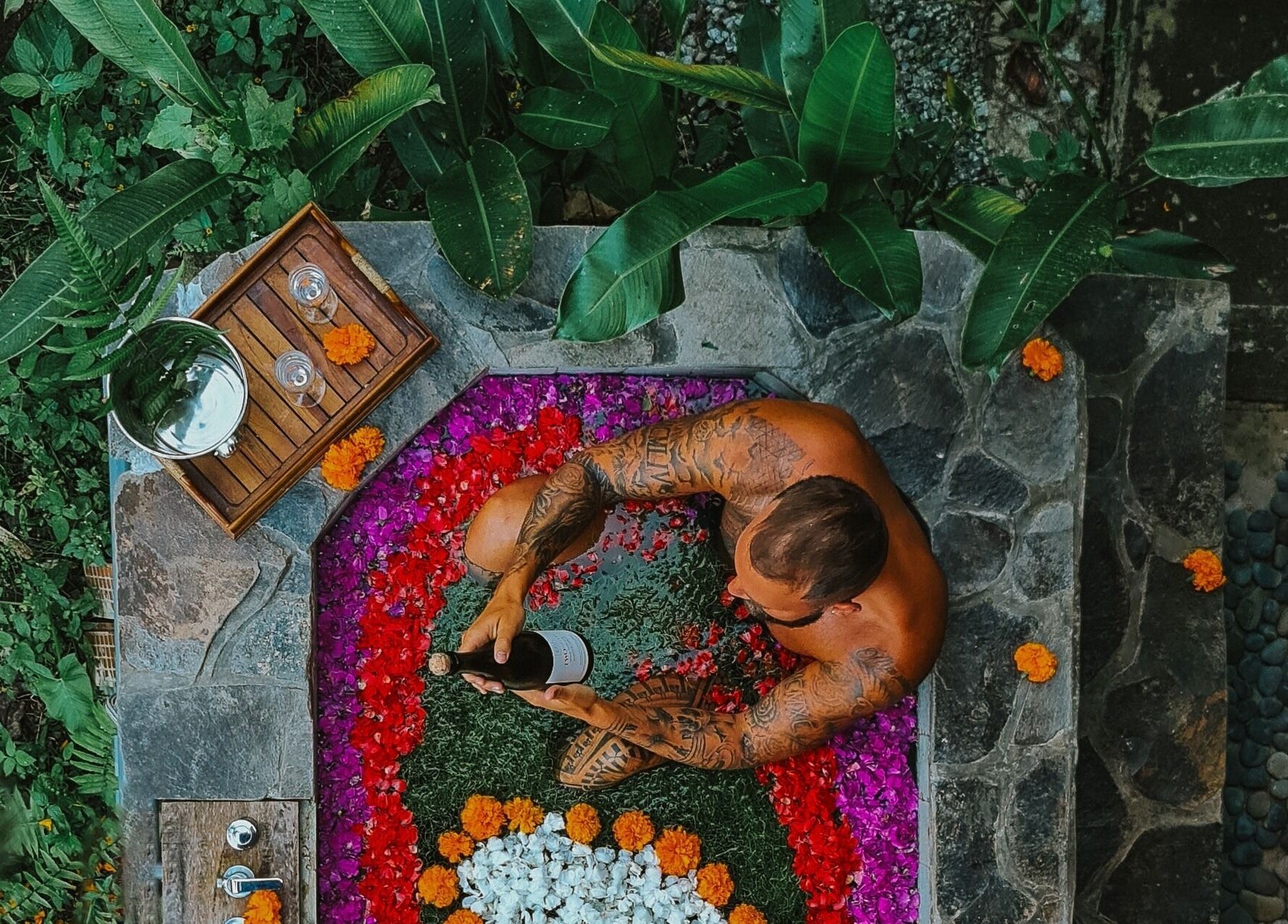 Luxurious flower bath experience at Sarira Healing Spa in Bali, Bali, ID, surrounded by lush greenery.
