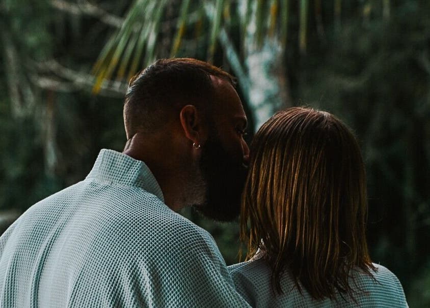 Couple enjoying peaceful moment at Sarira Healing Spa, Bali, Bali, ID, surrounded by lush greenery.