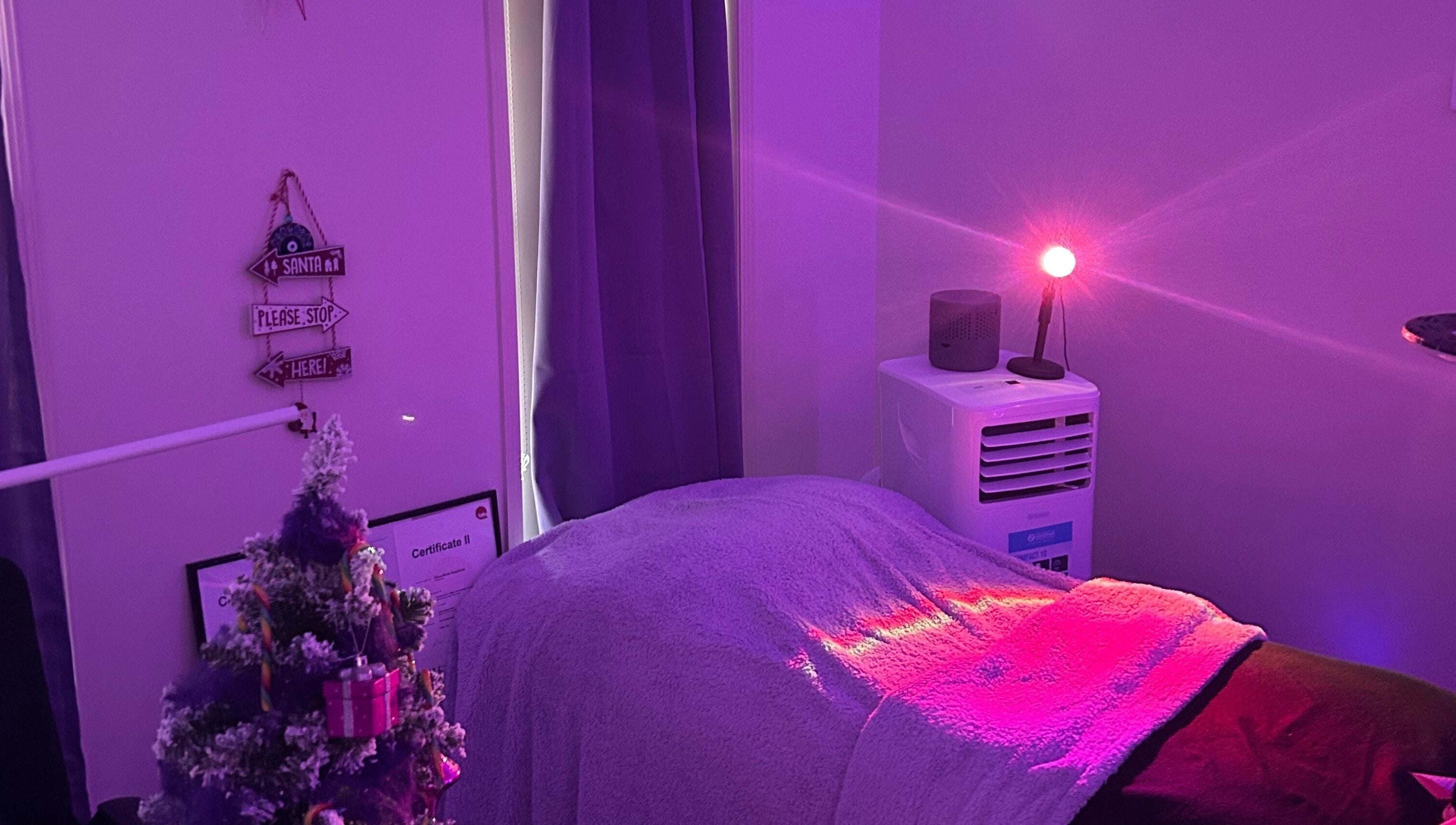 Tranquil treatment room at Glamor Beauty Bar, Meridan Plains, Queensland, AU with calming purple lights.