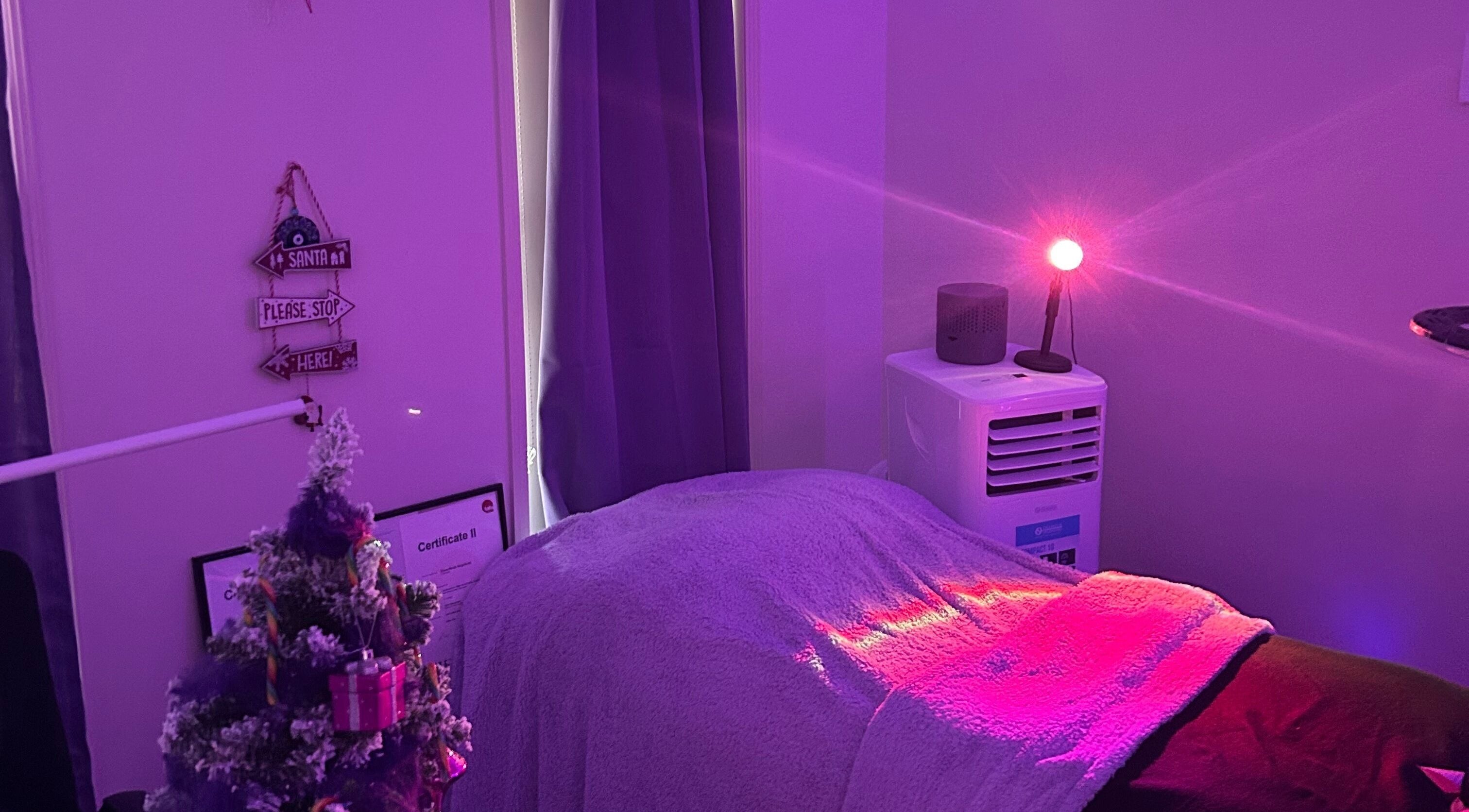 Tranquil treatment room at Glamor Beauty Bar, Meridan Plains, Queensland, AU with calming purple lights.