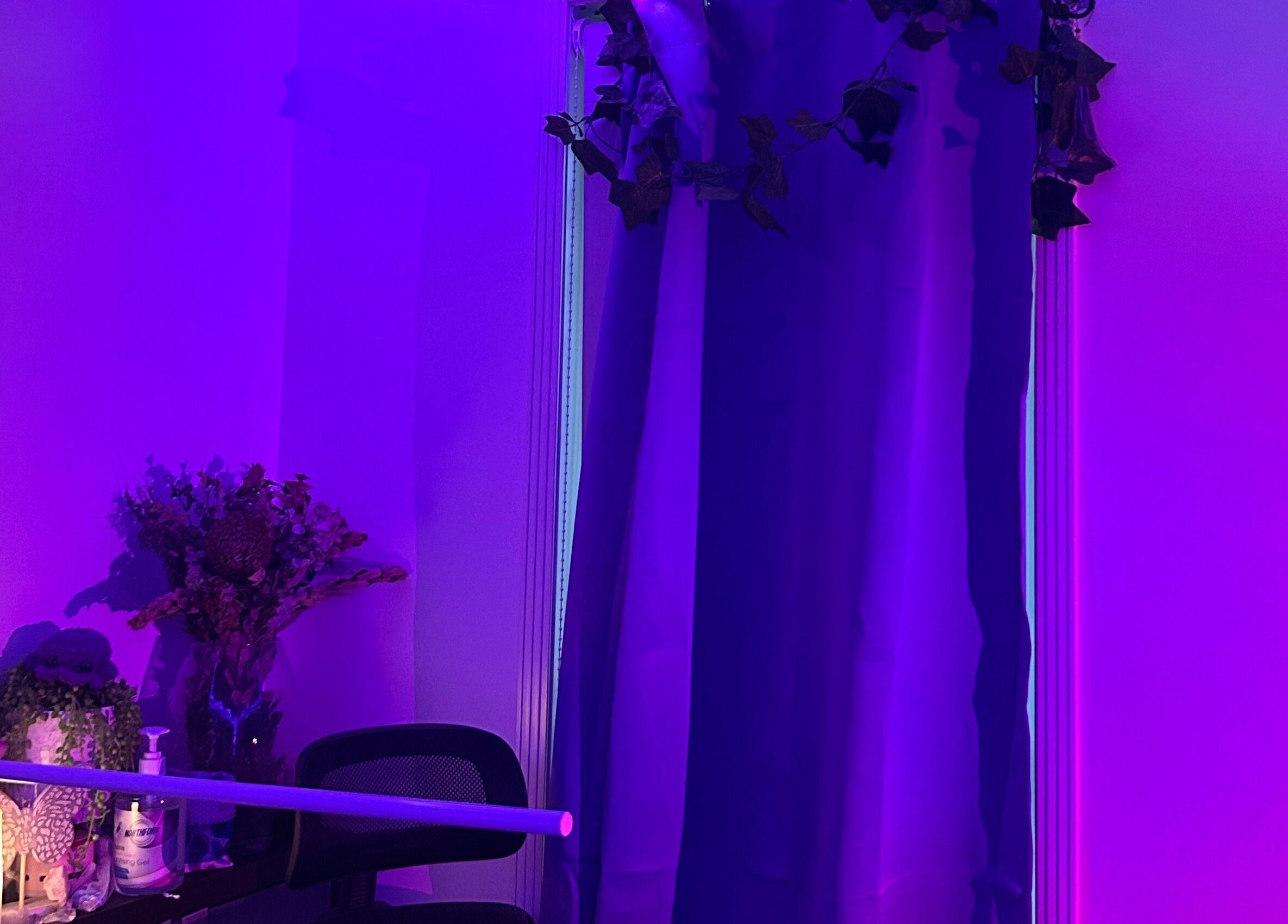 Relaxing purple-lit room at Glamor Beauty Bar in Meridan Plains, Queensland, AU with soothing decor and ambience.