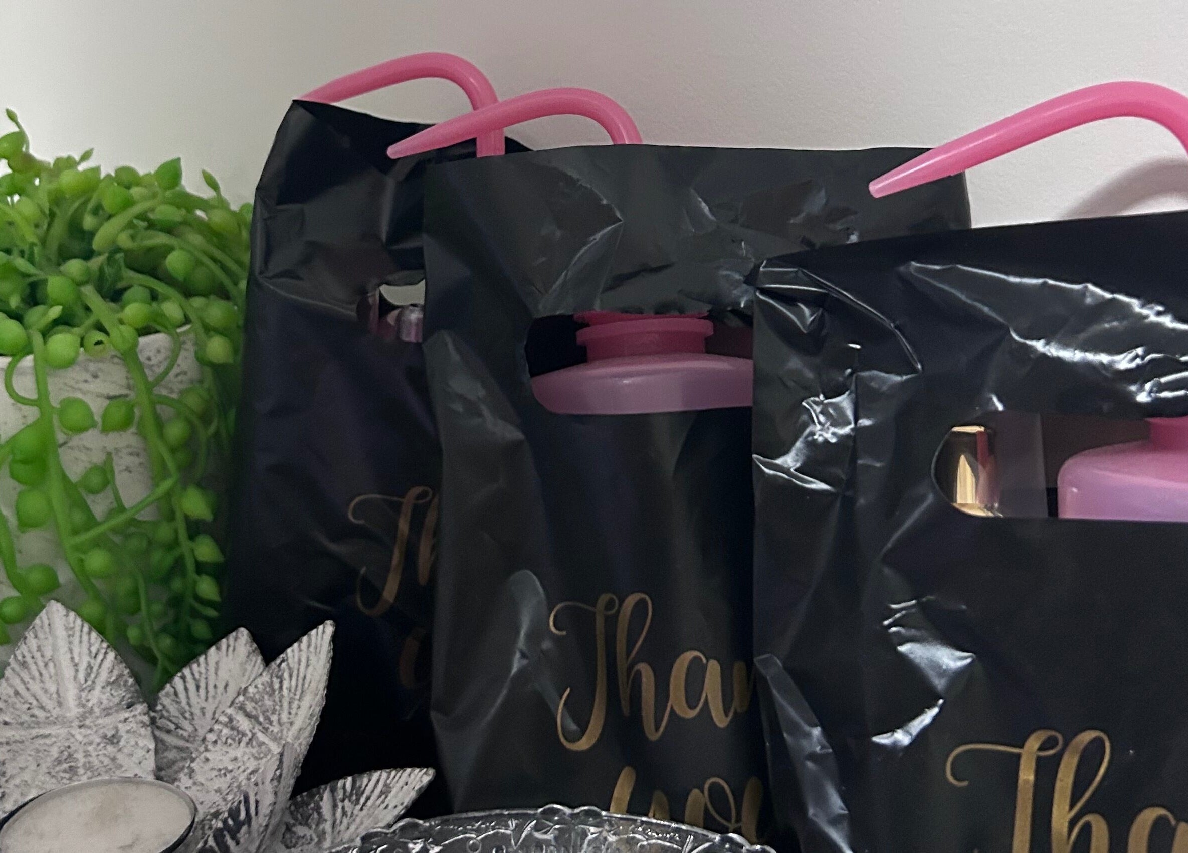 Decorative gift bags at Glamor Beauty Bar, Meridan Plains, Queensland, AU with lush green vines.