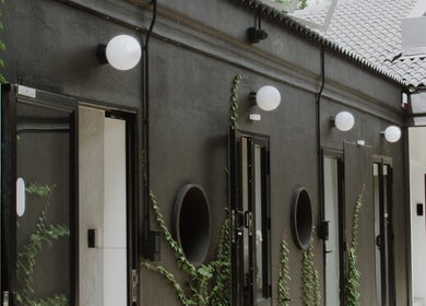 Modern courtyard at House of Kieulder in Pretoria, Gauteng, ZA with dark walls and greenery.