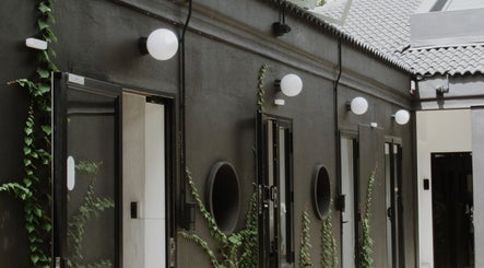 Modern courtyard at House of Kieulder in Pretoria, Gauteng, ZA with dark walls and greenery.