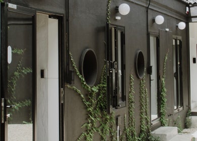 Elegant courtyard at House of Kieulder, Pretoria, Gauteng, ZA with sleek black walls and green vines.