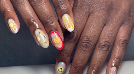 Colorful nail art featuring sun, flames, and smiley designs at Nails By LB in Alfreton, England, GB.
