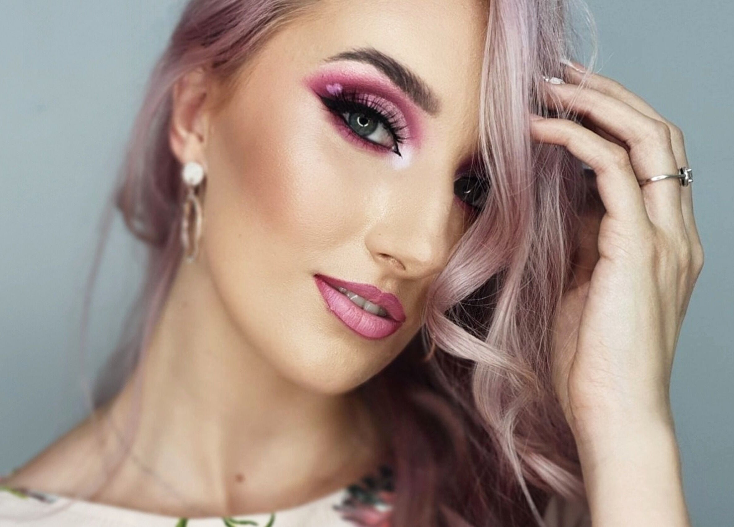 Woman with vibrant makeup by Kryolan Silver Lakes, Shere, Gauteng, ZA. Perfect pink hues enhance her look.