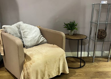 Comfortable seating area at AR Sports Massage, London, England, GB with plush chair and modern decor.