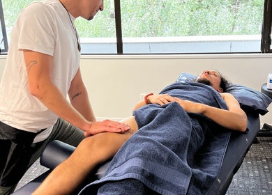 Massage therapist working on a client's leg at AR Sports Massage, London, England, GB.