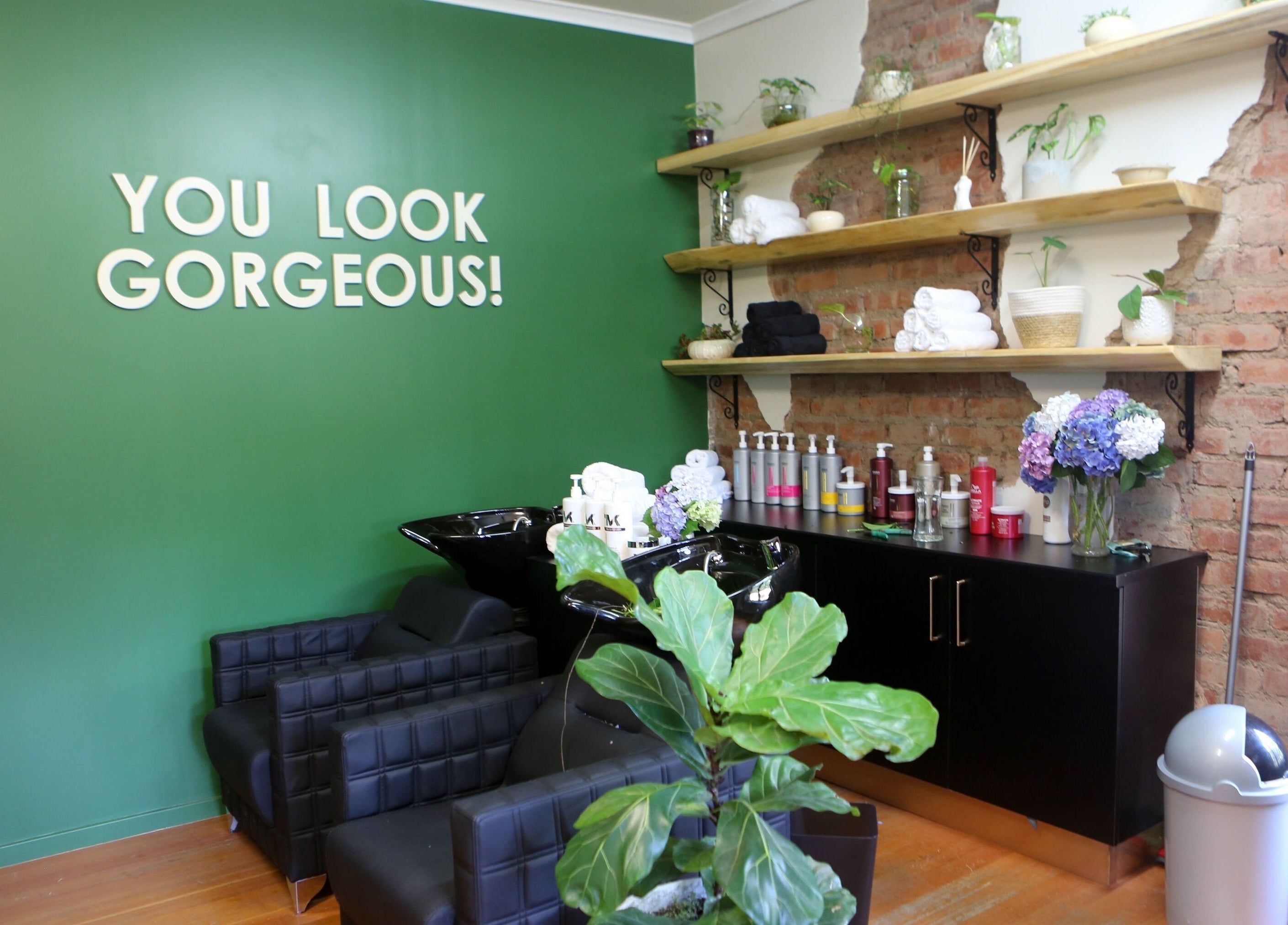 Chic interior of Hair By Caryn Timms, Pietermaritzburg, Kwazulu-natal, ZA, featuring styling chairs and vibrant decor.