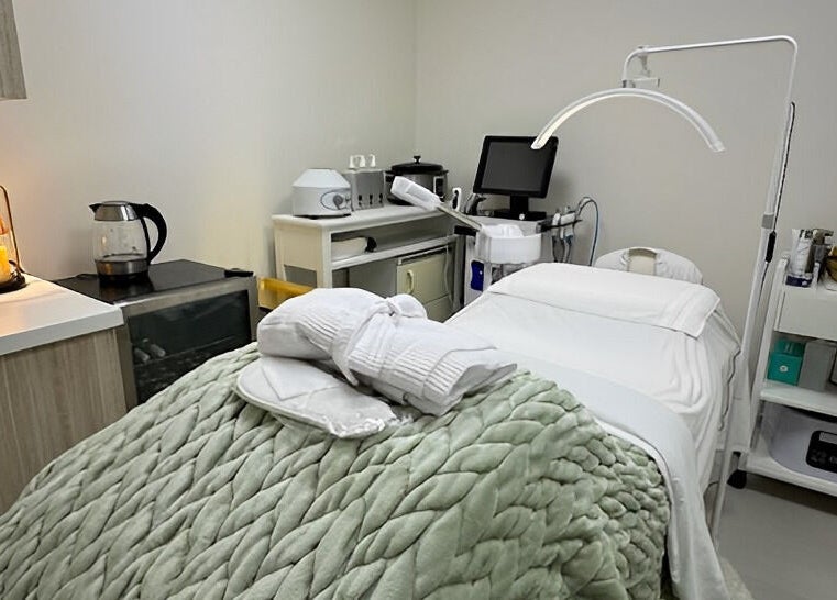 Cozy treatment room at Touch Of Spa By Sol, Pembroke Pines, Florida, US with plush blanket and spa equipment.