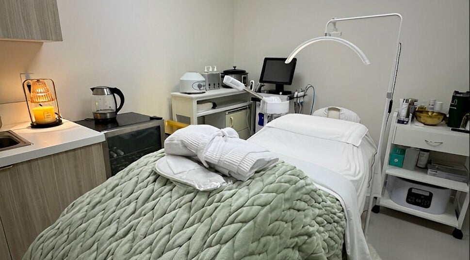 Cozy treatment room at Touch Of Spa By Sol, Pembroke Pines, Florida, US with plush blanket and spa equipment.