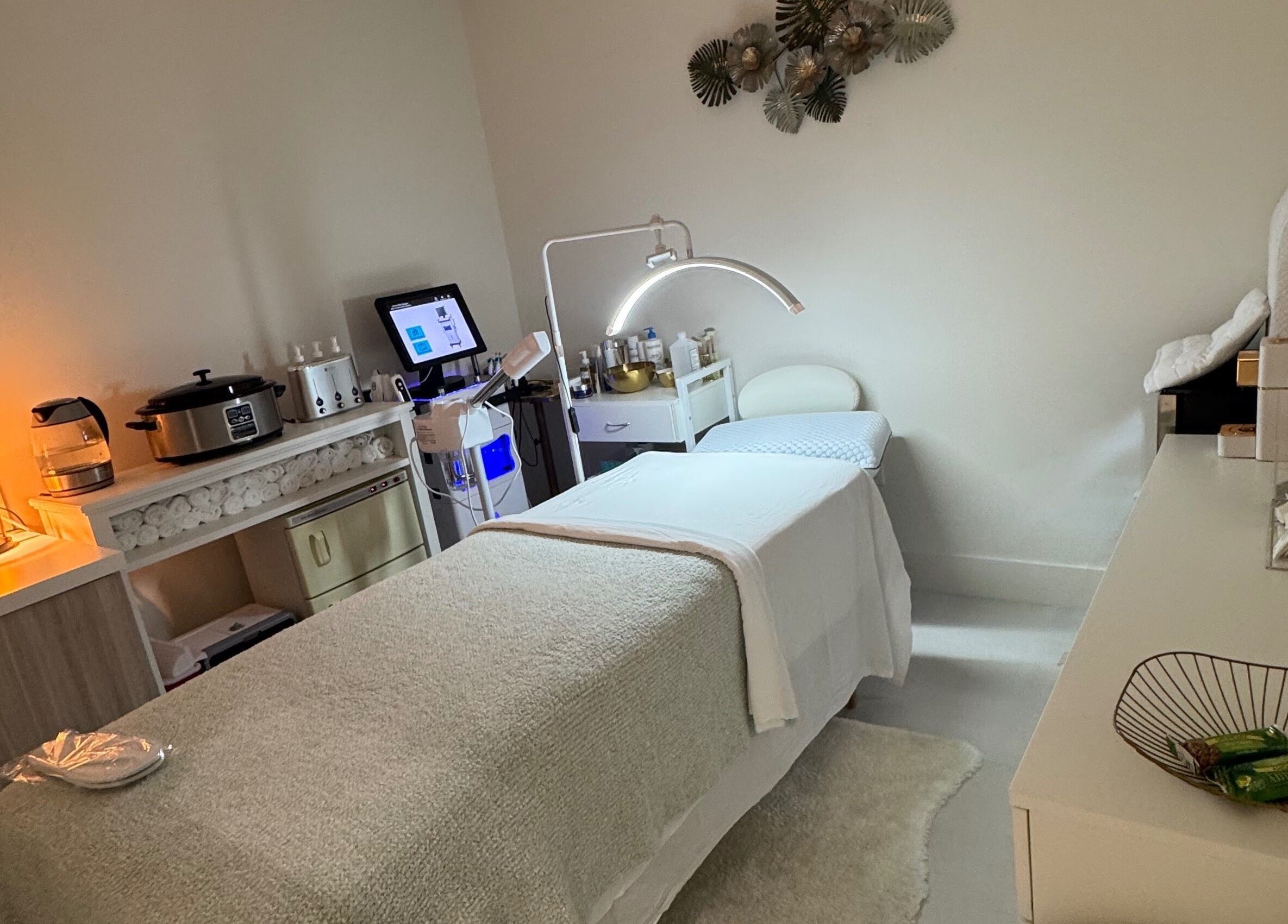 Cozy treatment room at Touch Of Spa By Sol in Pembroke Pines, Florida, US featuring a comfortable massage bed.