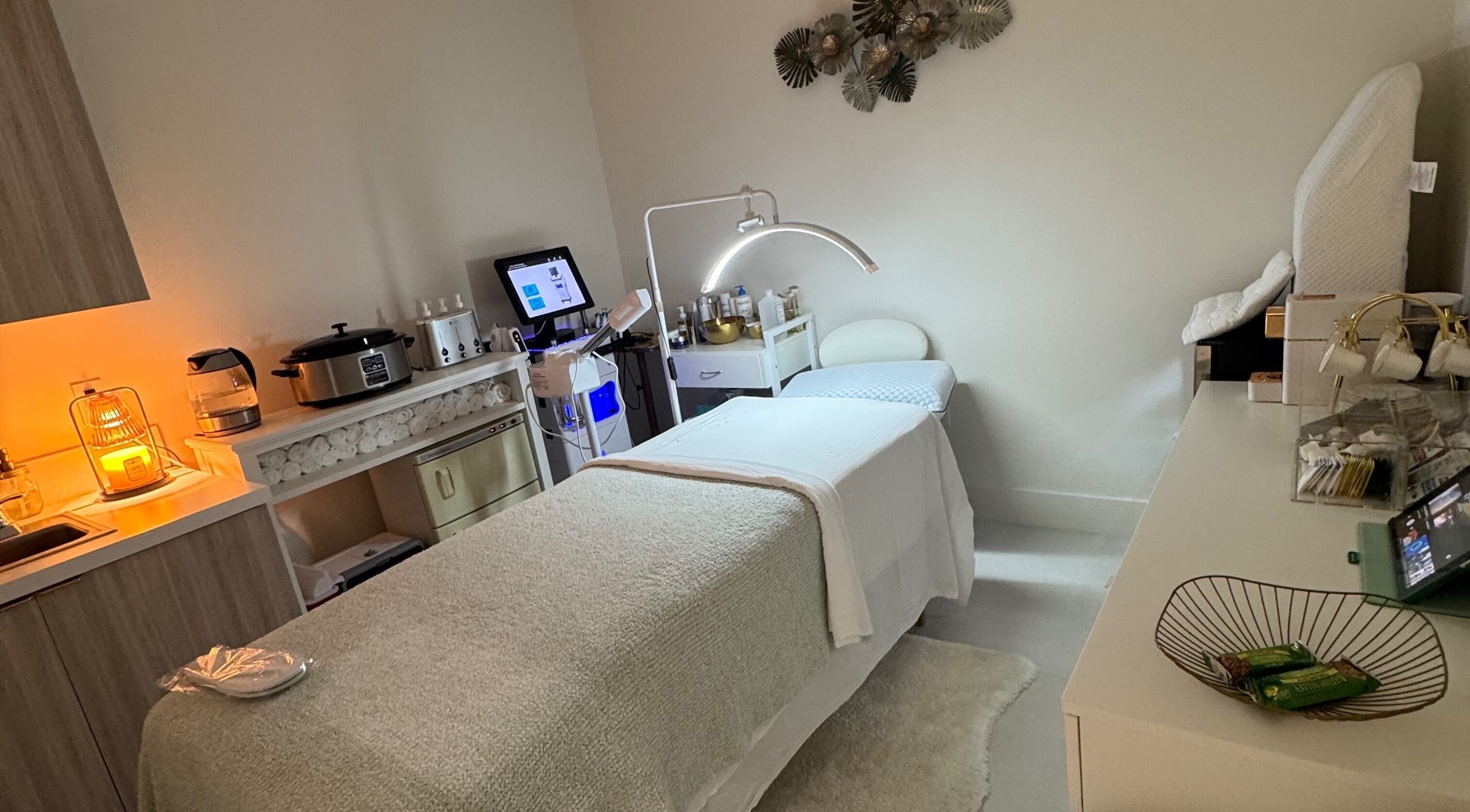 Cozy treatment room at Touch Of Spa By Sol in Pembroke Pines, Florida, US featuring a comfortable massage bed.