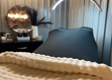 Relaxing massage table at Lami Lounge UK, Spalding, England, GB with a plush blanket and ambient lighting.