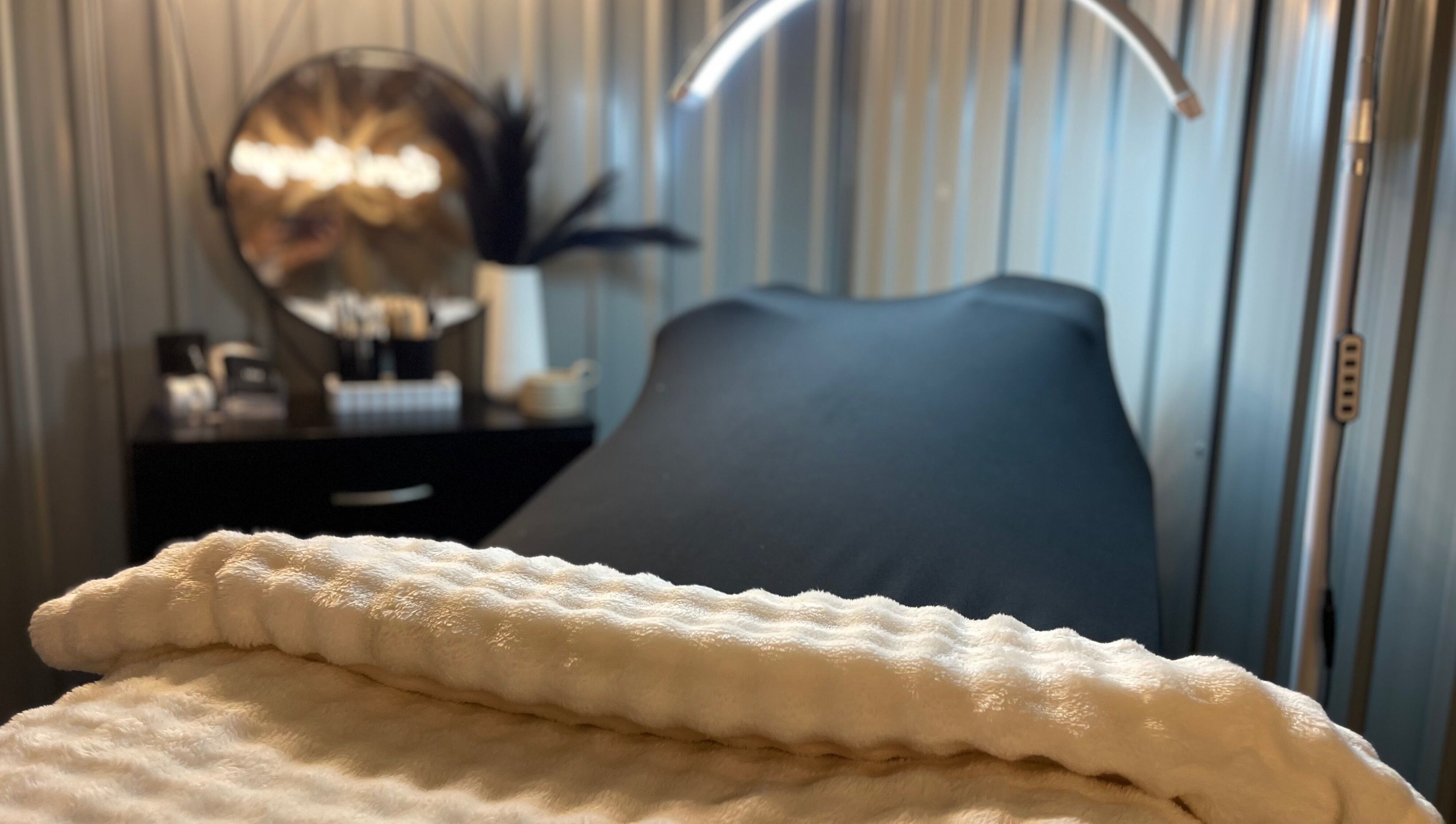 Relaxing treatment room at Lami Lounge UK, Spalding, England, GB, featuring a plush white towel and ambiance.