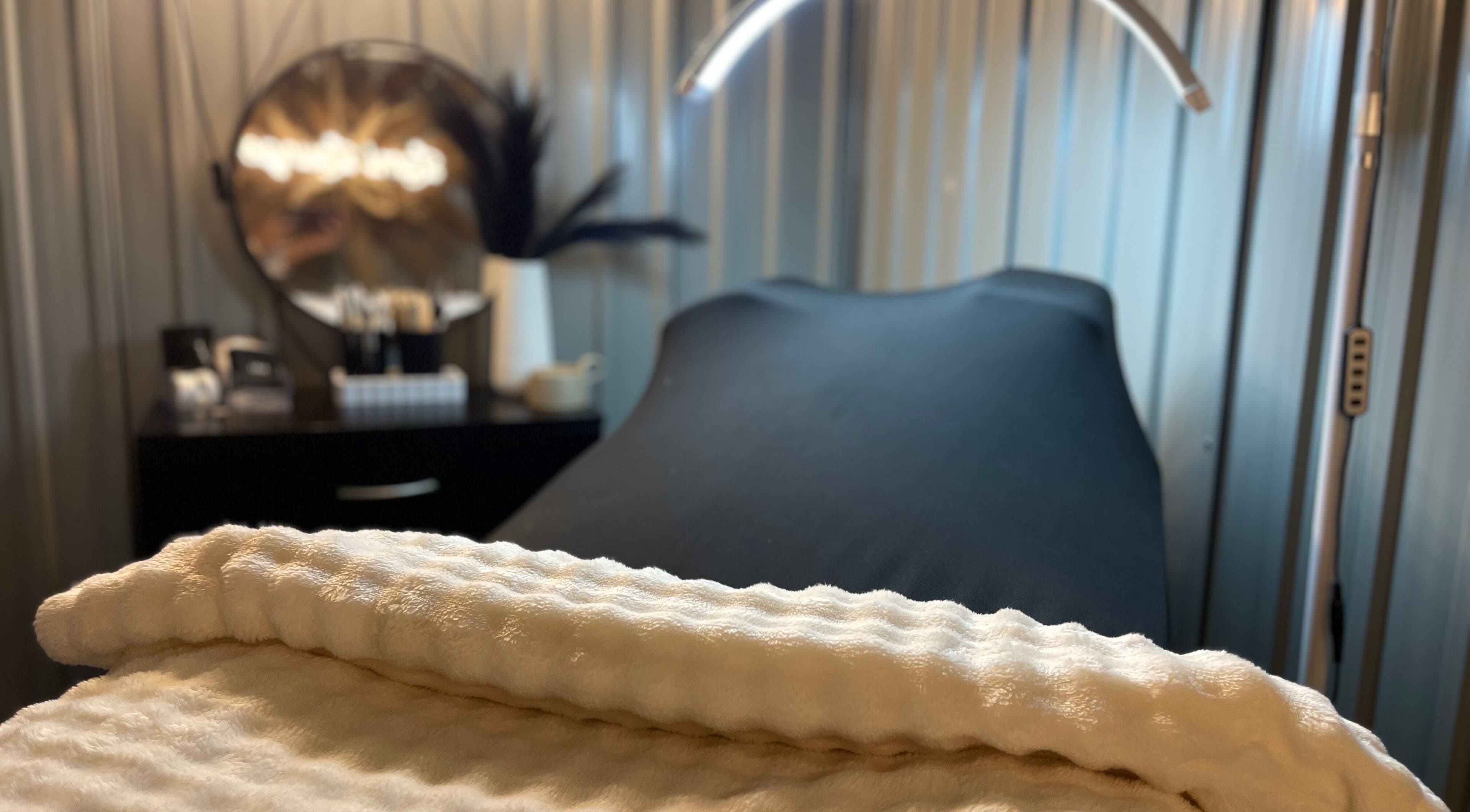 Relaxing treatment room at Lami Lounge UK, Spalding, England, GB, featuring a plush white towel and ambiance.