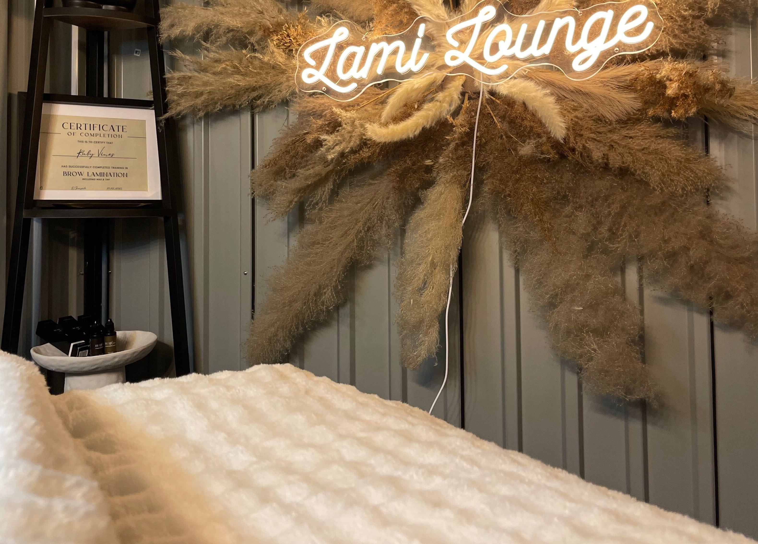 Warm interior of Lami Lounge UK in Spalding, England, GB with neon sign and pampas decor.